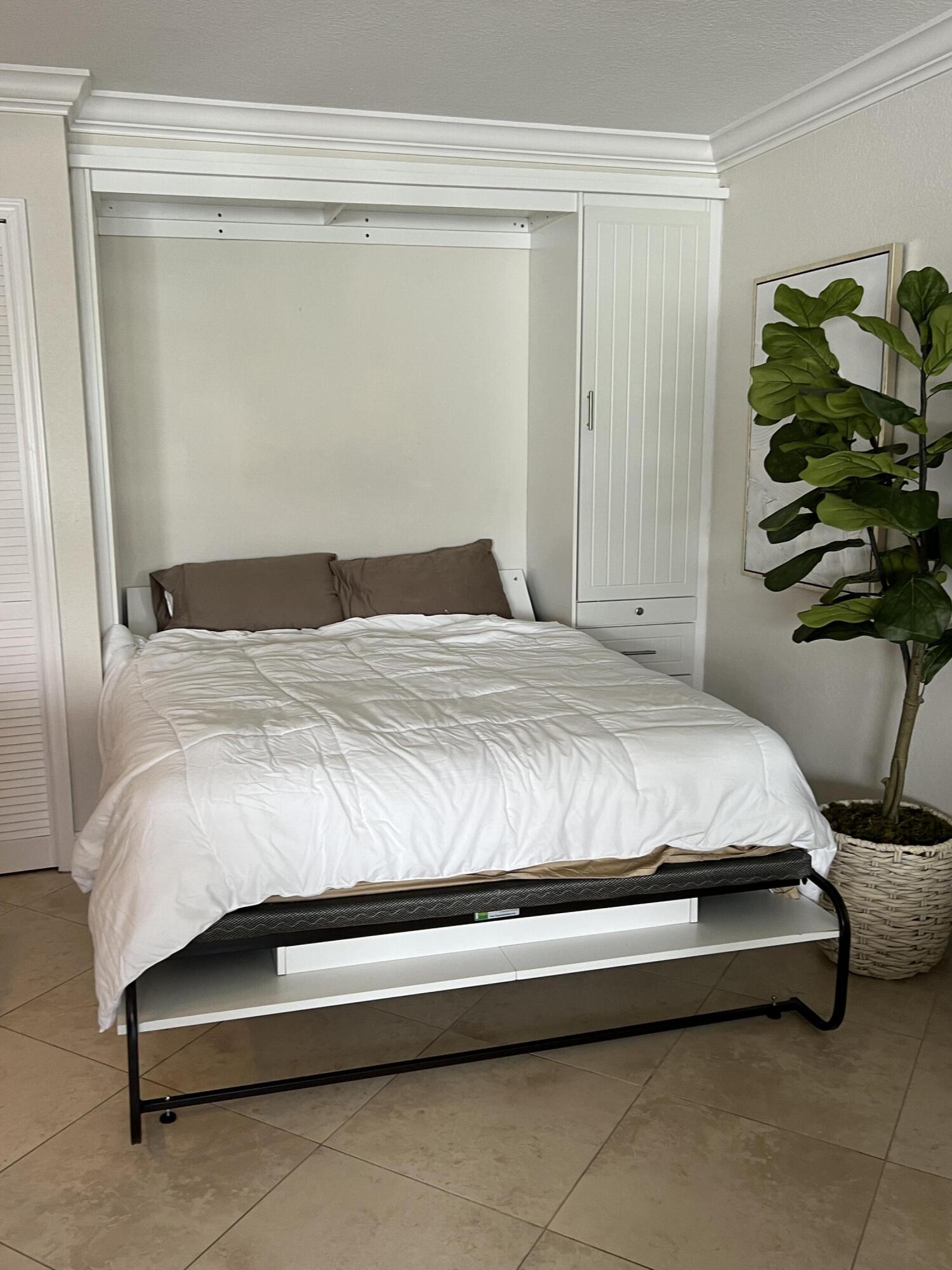 330 Southeast 20th Avenue, Unit 315 Deerfield Beach, FL 33441 - Photo 15 of 33 a bedroom with a bed and a potted plant