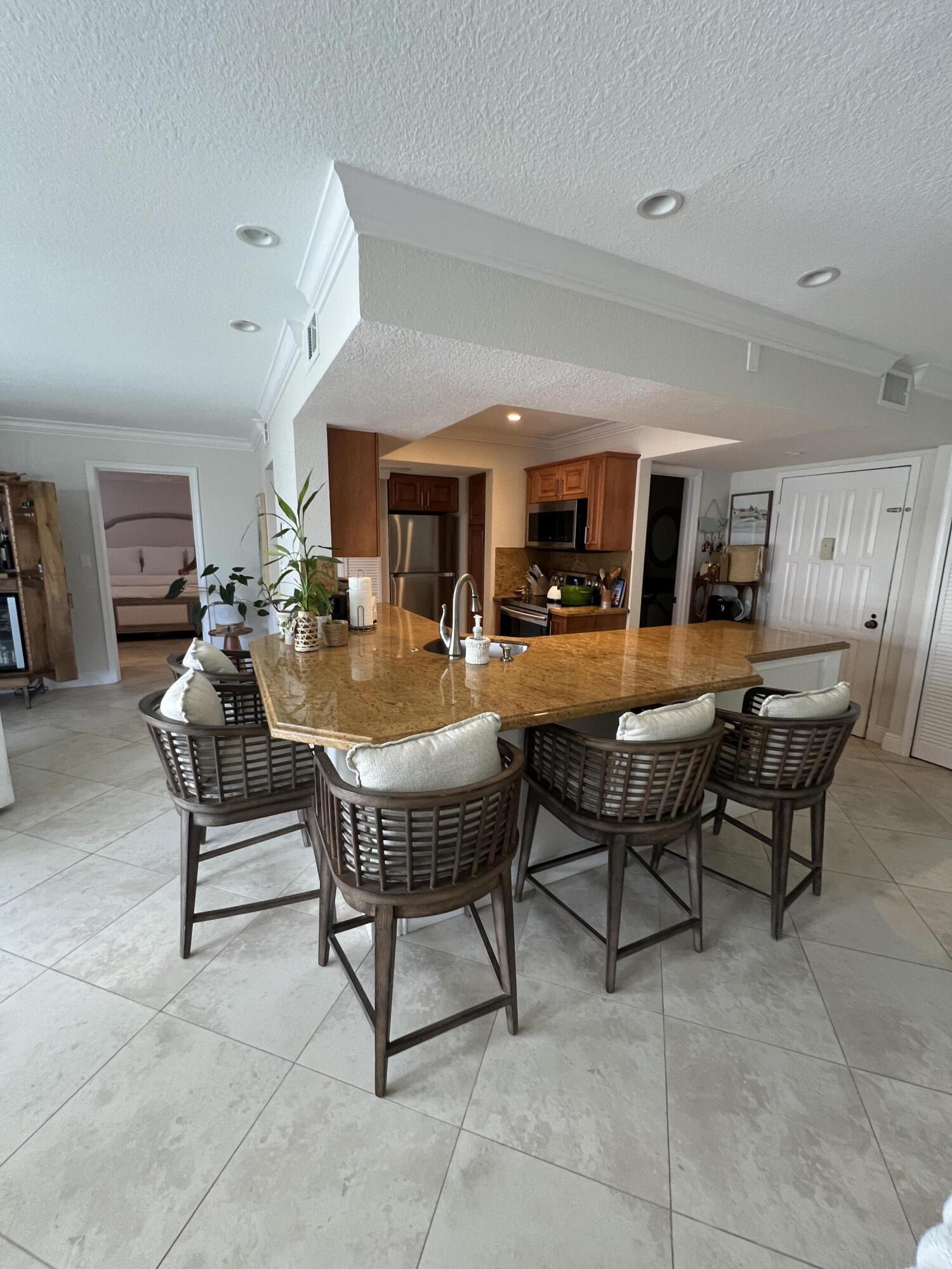 330 Southeast 20th Avenue, Unit 315 Deerfield Beach, FL 33441 - Photo 16 of 33 a living room with furniture a dining table and chairs