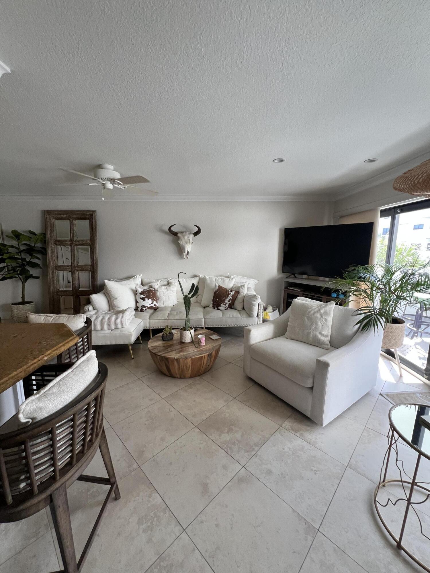 330 Southeast 20th Avenue, Unit 315 Deerfield Beach, FL 33441 - Photo 17 of 33 a living room with furniture and a flat screen tv