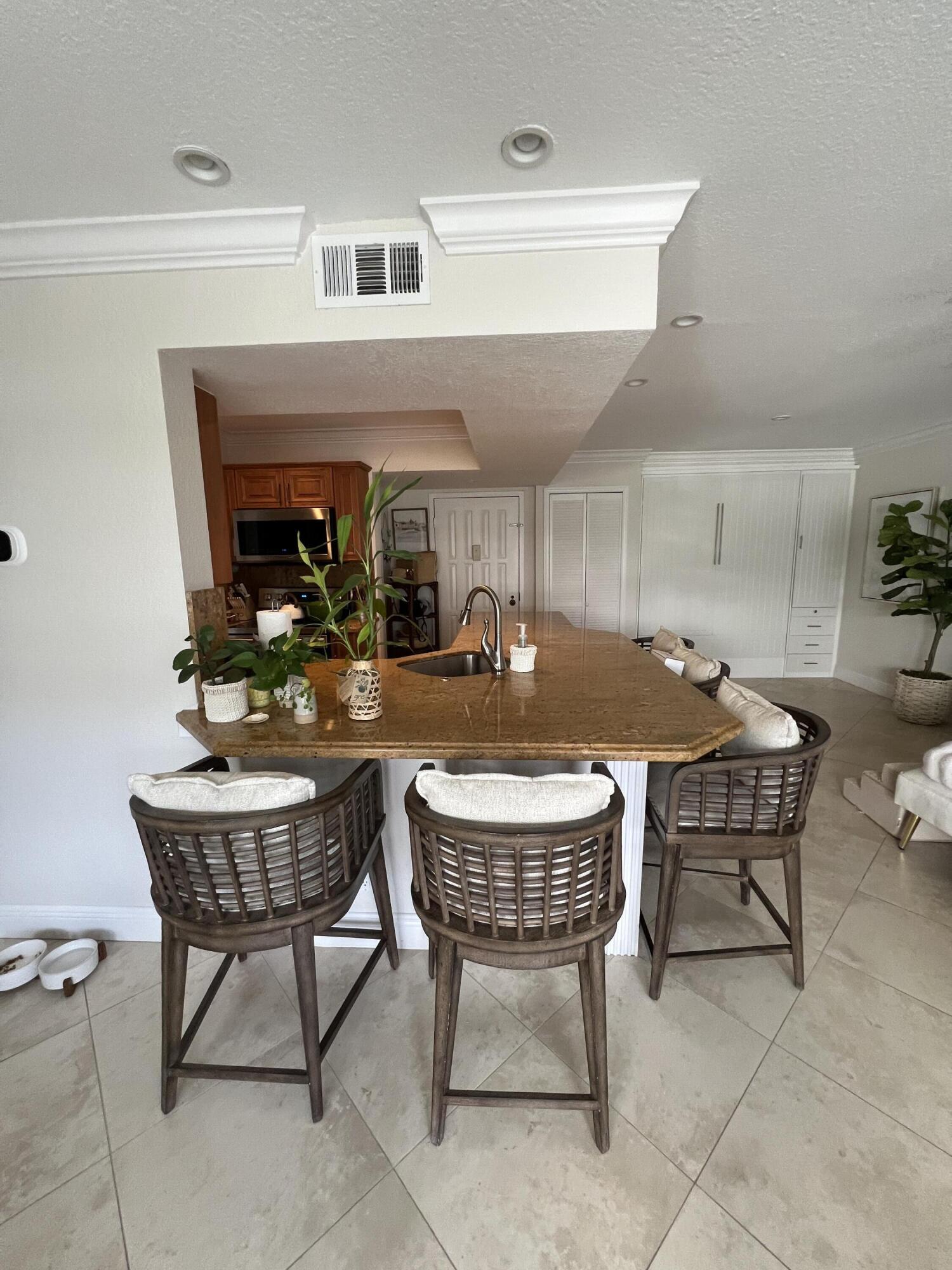 330 Southeast 20th Avenue, Unit 315 Deerfield Beach, FL 33441 - Photo 18 of 33 a kitchen with a table and chairs in it