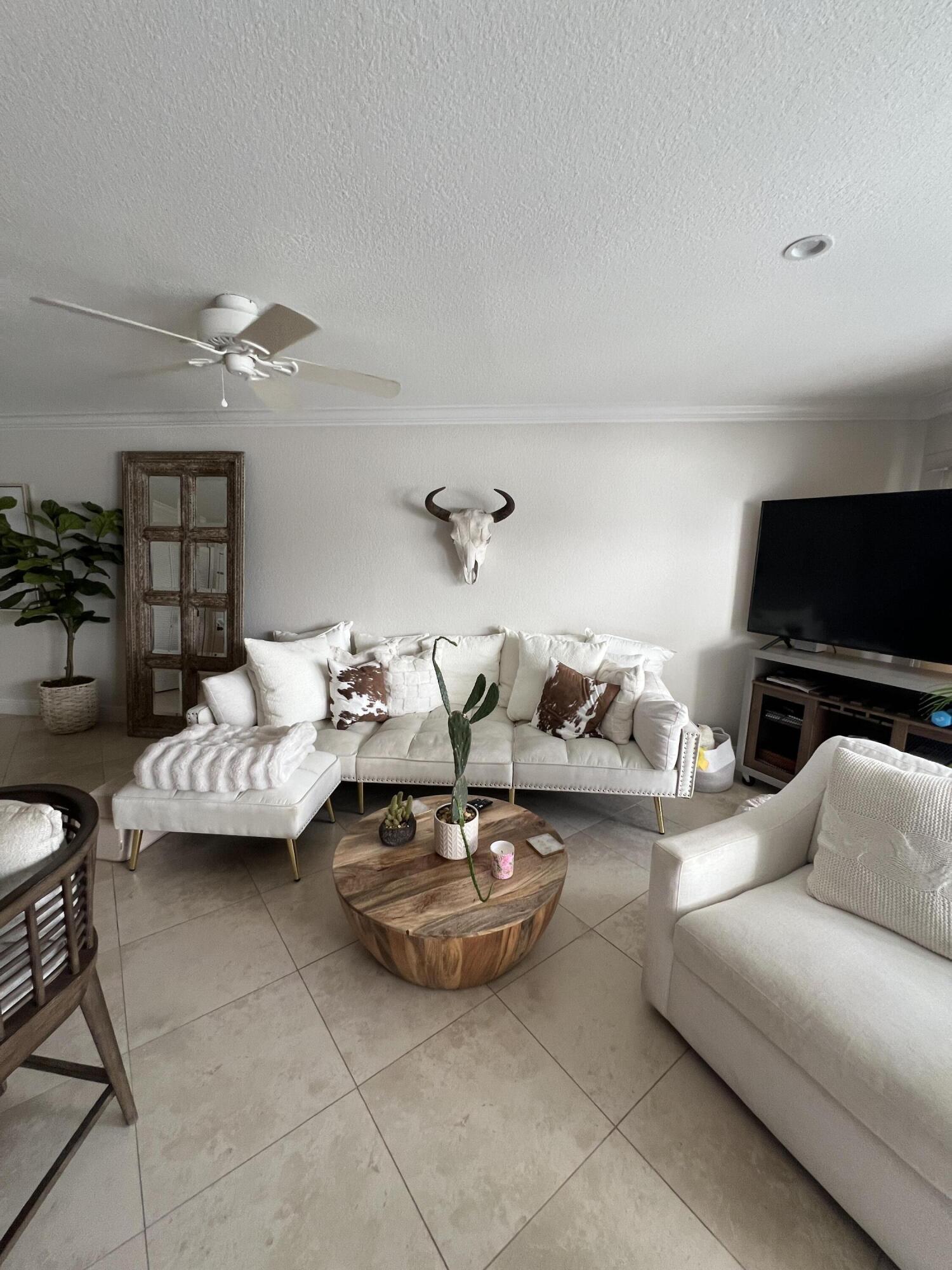 330 Southeast 20th Avenue, Unit 315 Deerfield Beach, FL 33441 - Photo 19 of 33 a living room with furniture and a flat screen tv