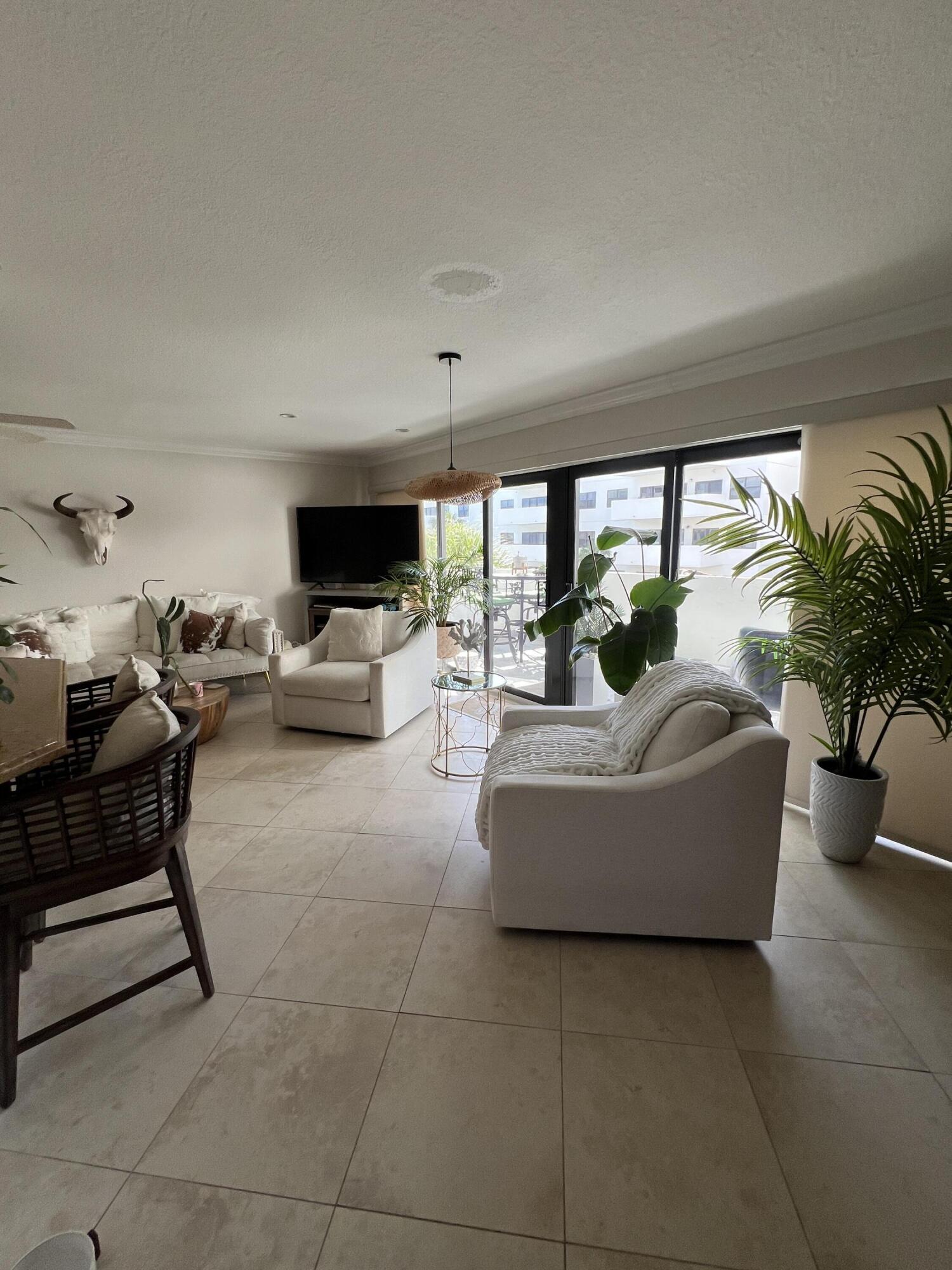 330 Southeast 20th Avenue, Unit 315 Deerfield Beach, FL 33441 - Photo 21 of 33 a living room with furniture and a large window