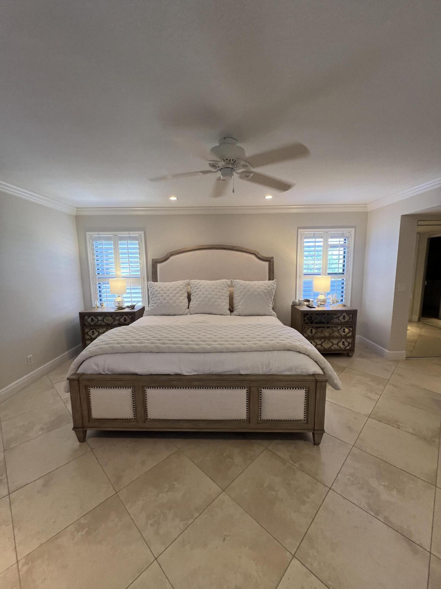 330 Southeast 20th Avenue, Unit 315 Deerfield Beach, FL 33441 - Photo 24 of 33 a bedroom with a bed and wooden floor