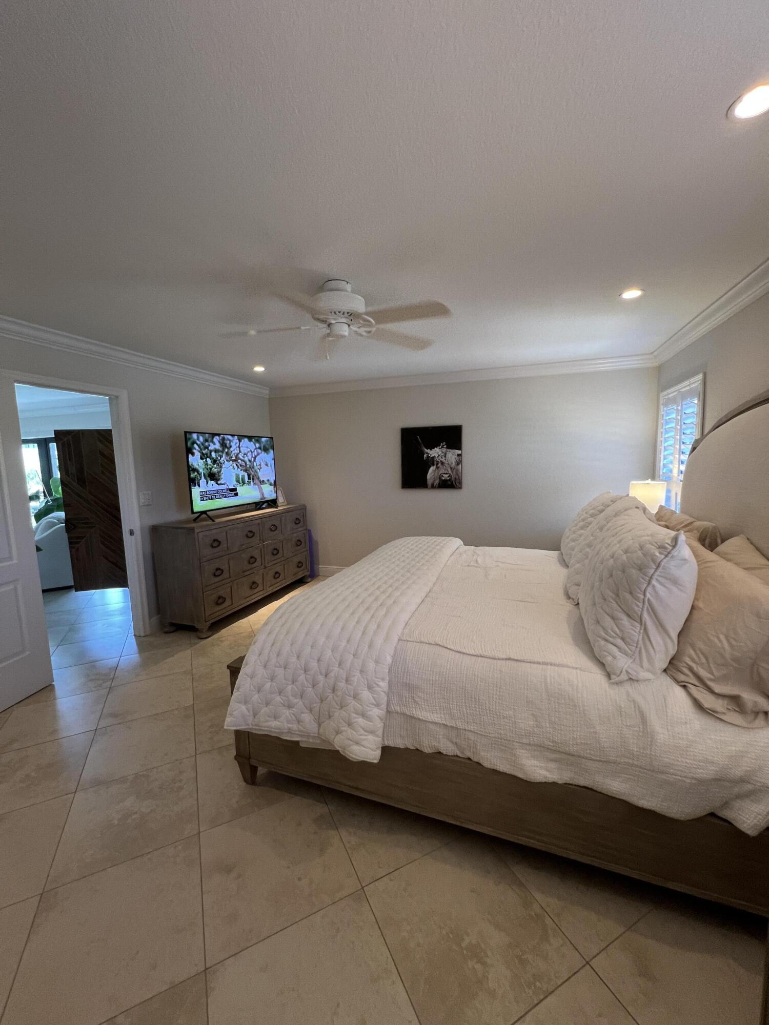 330 Southeast 20th Avenue, Unit 315 Deerfield Beach, FL 33441 - Photo 26 of 33 a bedroom with a bed and utility