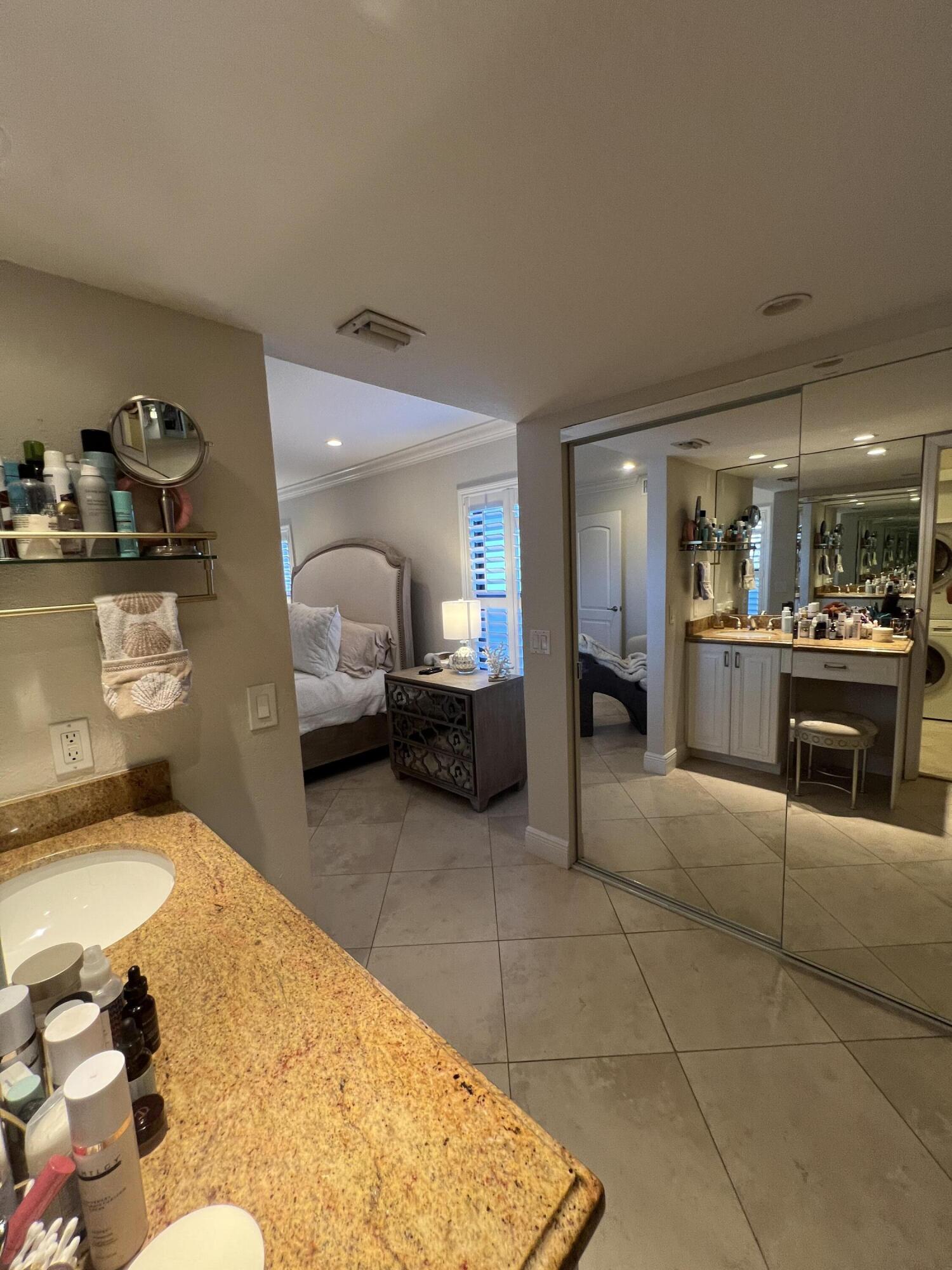 330 Southeast 20th Avenue, Unit 315 Deerfield Beach, FL 33441 - Photo 29 of 33 a en suite bathroom with a sink and a mirror