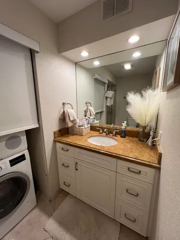 a bathroom with a double vanity sink and mirror