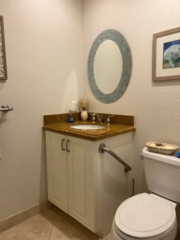 a bathroom with a toilet a sink and mirror