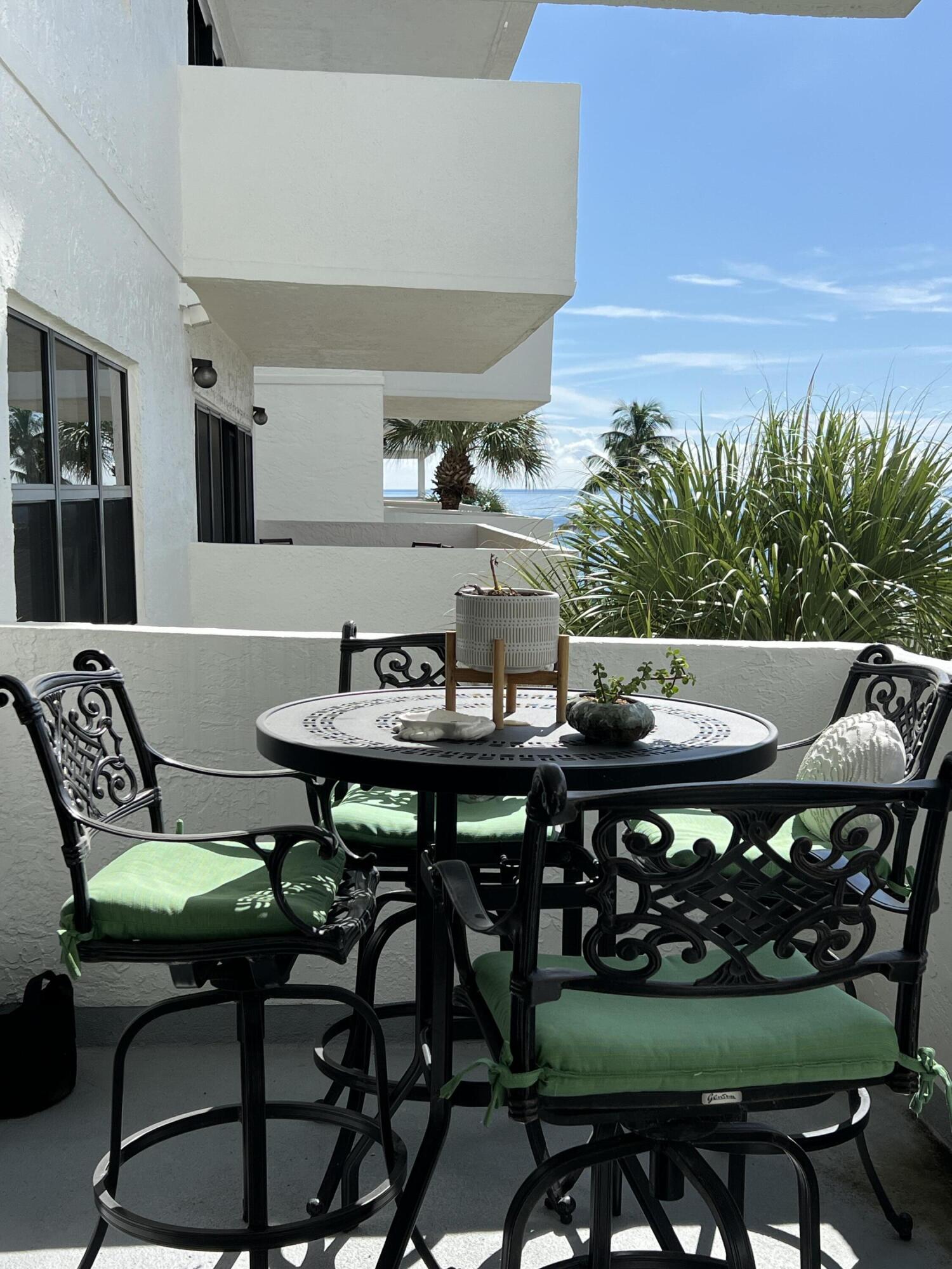 330 Southeast 20th Avenue, Unit 315 Deerfield Beach, FL 33441 - Photo 5 of 33 a view of a table and chairs in the patio