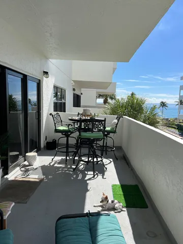 a living room with dining room and couches chair