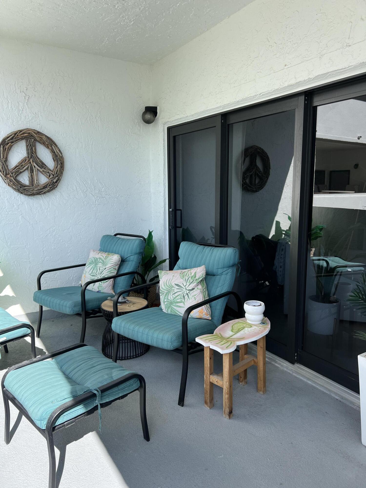 330 Southeast 20th Avenue, Unit 315 Deerfield Beach, FL 33441 - Photo 9 of 33 a living room with furniture and a lamp