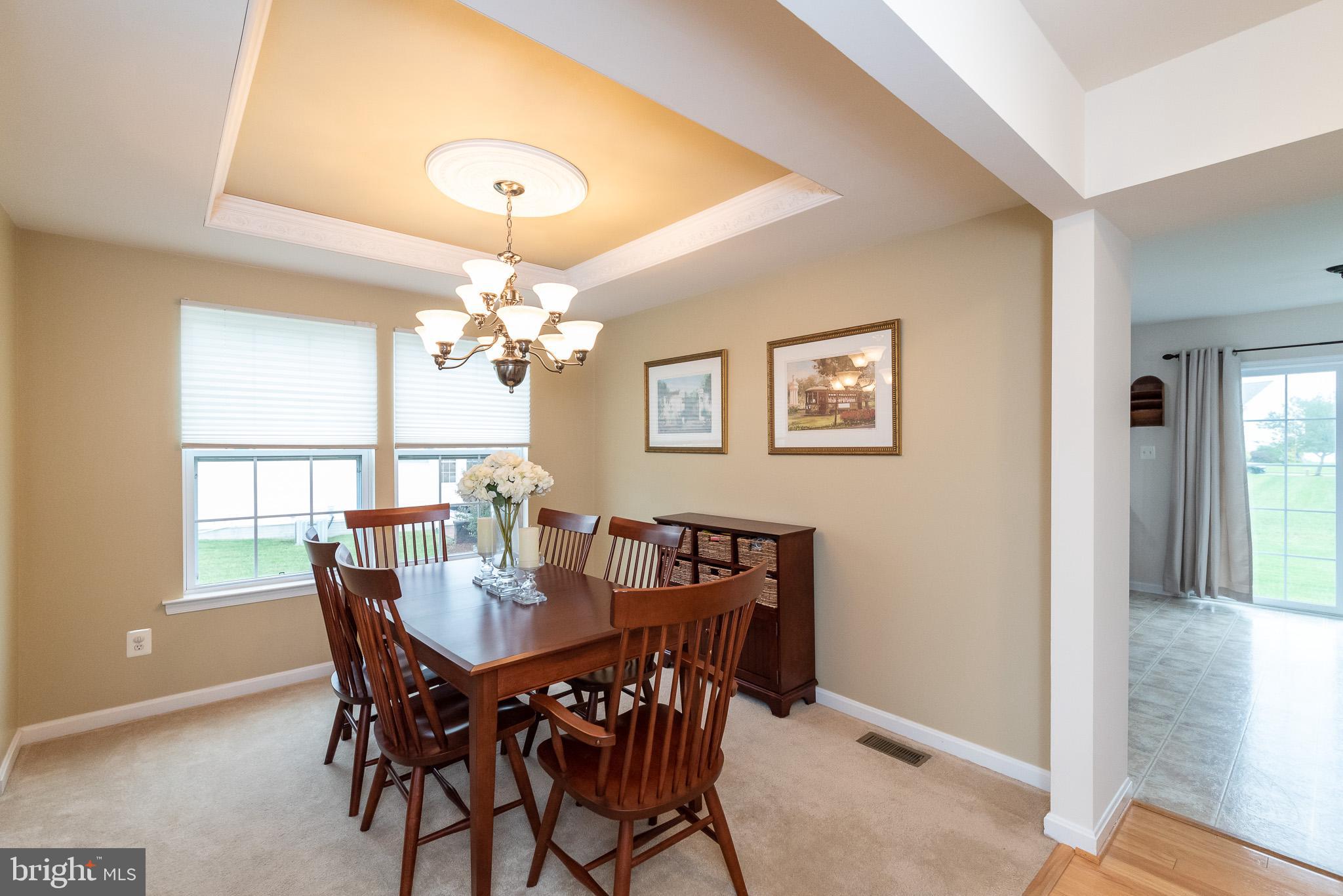 709 Walnut Grove Road Baltimore, MD 21221 - Photo 13 of 52 a dining room with furniture and chandelier