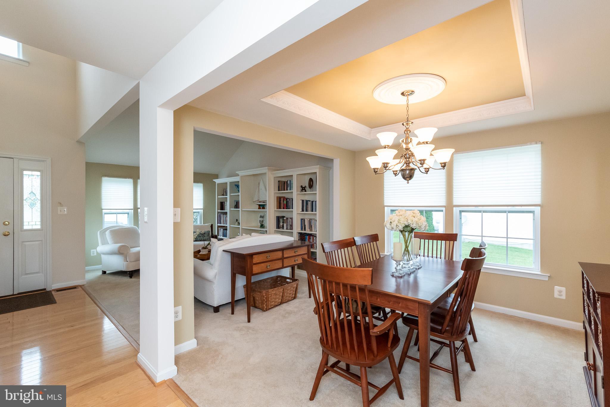709 Walnut Grove Road Baltimore, MD 21221 - Photo 14 of 52 a view of a dining room with furniture and a chandelier