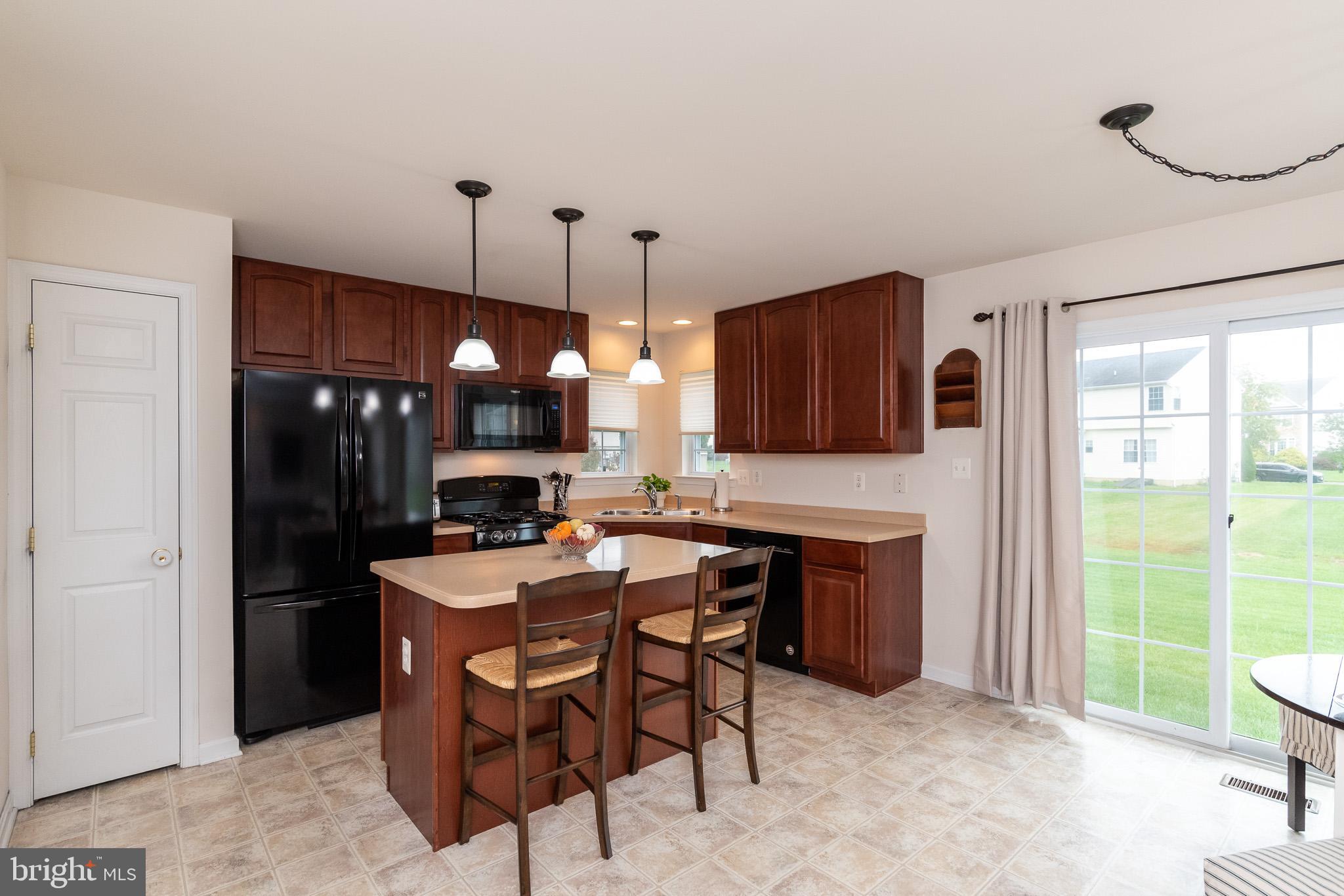 709 Walnut Grove Road Baltimore, MD 21221 - Photo 16 of 52 a kitchen with a table and chairs in it