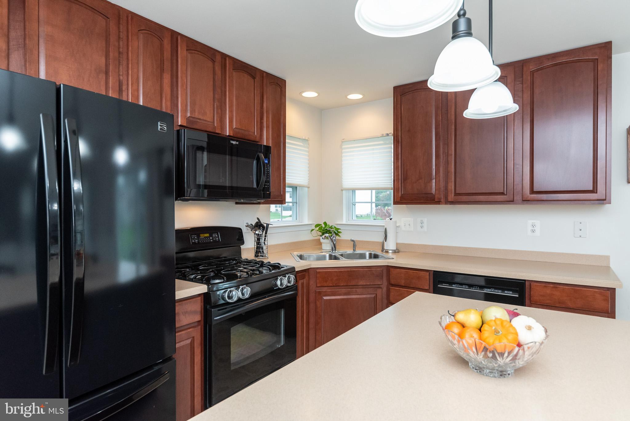 709 Walnut Grove Road Baltimore, MD 21221 - Photo 18 of 52 a kitchen with stainless steel appliances a stove refrigerator sink and cabinets