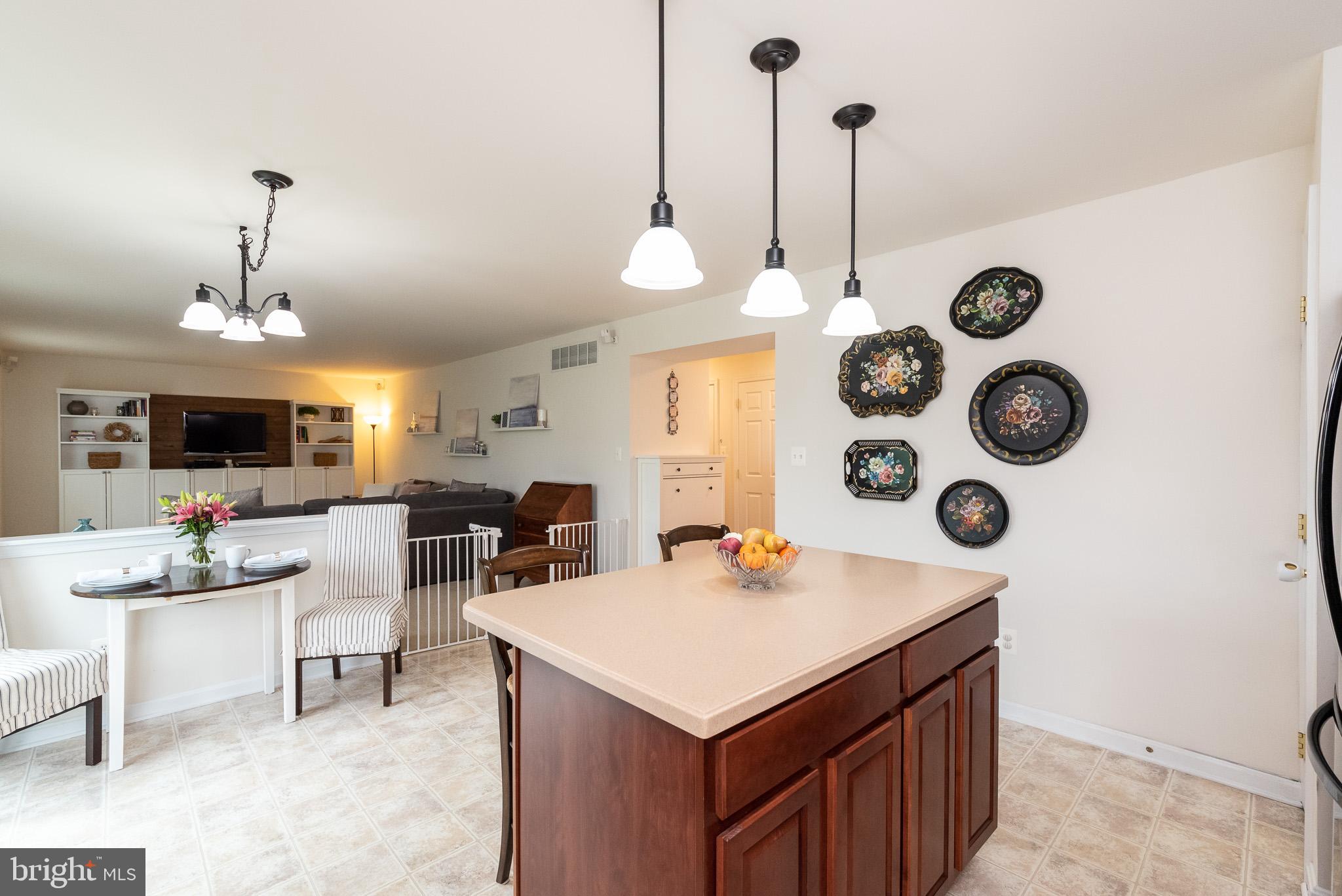 709 Walnut Grove Road Baltimore, MD 21221 - Photo 20 of 52 a kitchen with a table a stove and a wooden floor