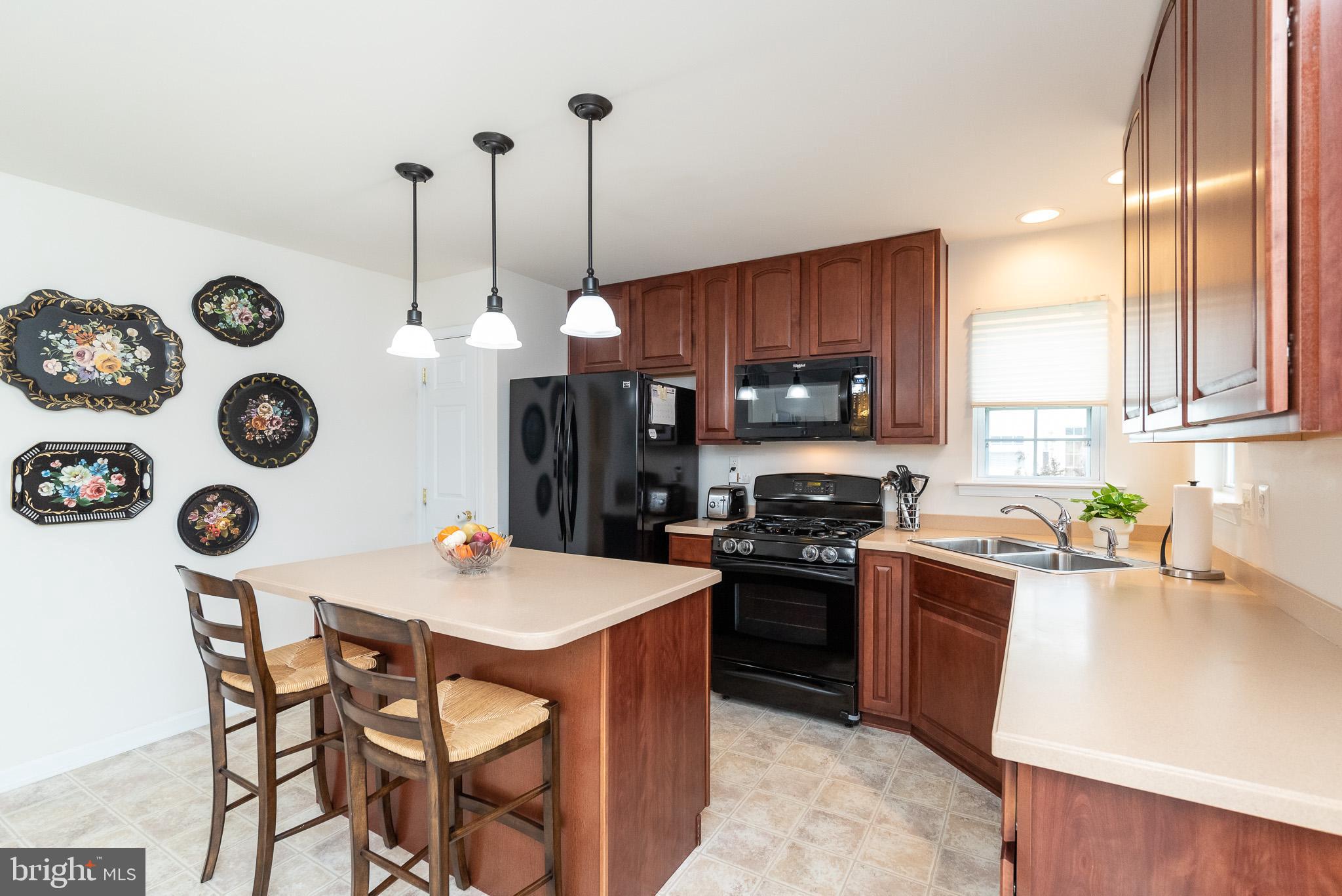 709 Walnut Grove Road Baltimore, MD 21221 - Photo 21 of 52 a kitchen with a table chairs and stove