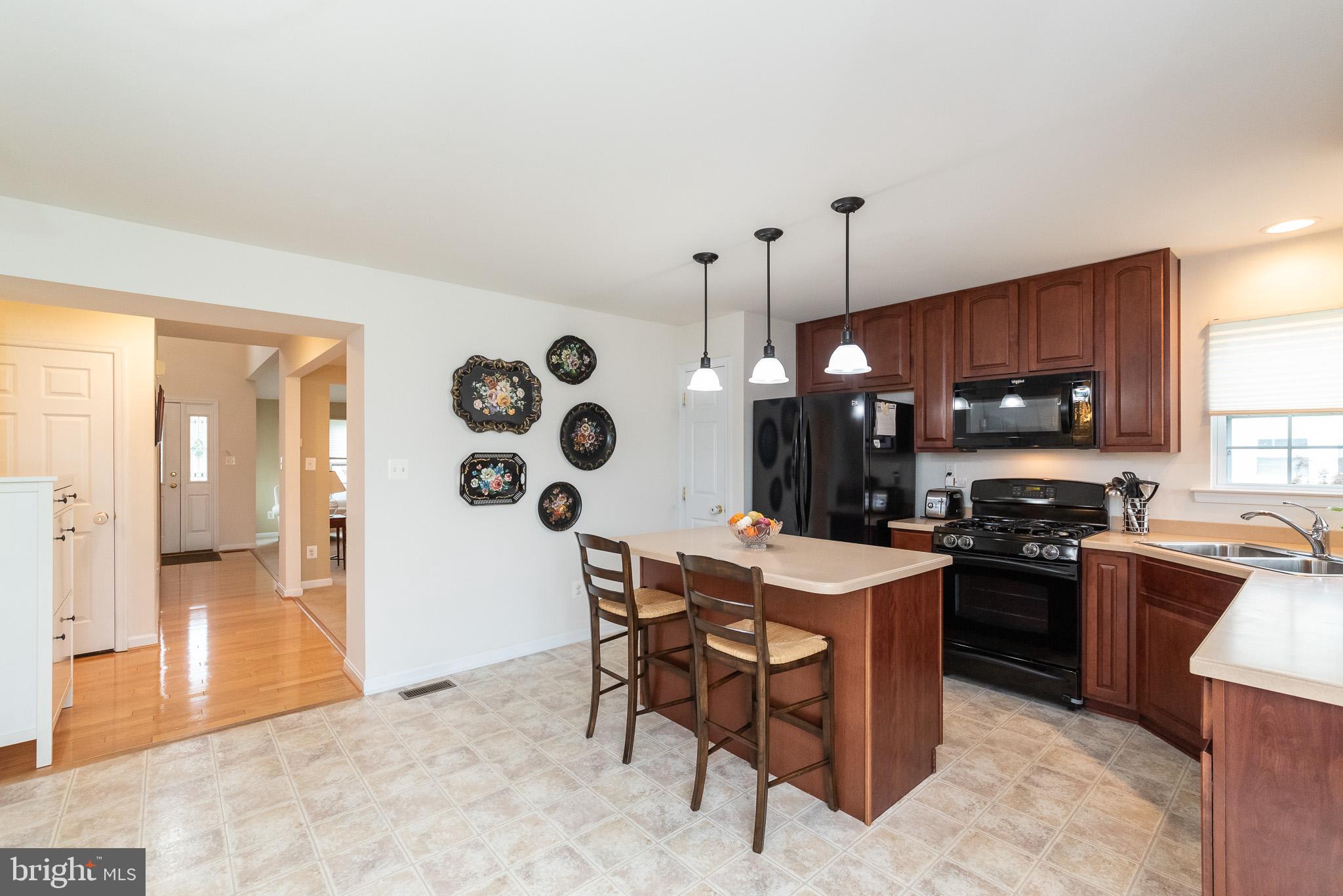 709 Walnut Grove Road Baltimore, MD 21221 - Photo 22 of 52 a kitchen with stainless steel appliances granite countertop a sink a stove and a refrigerator