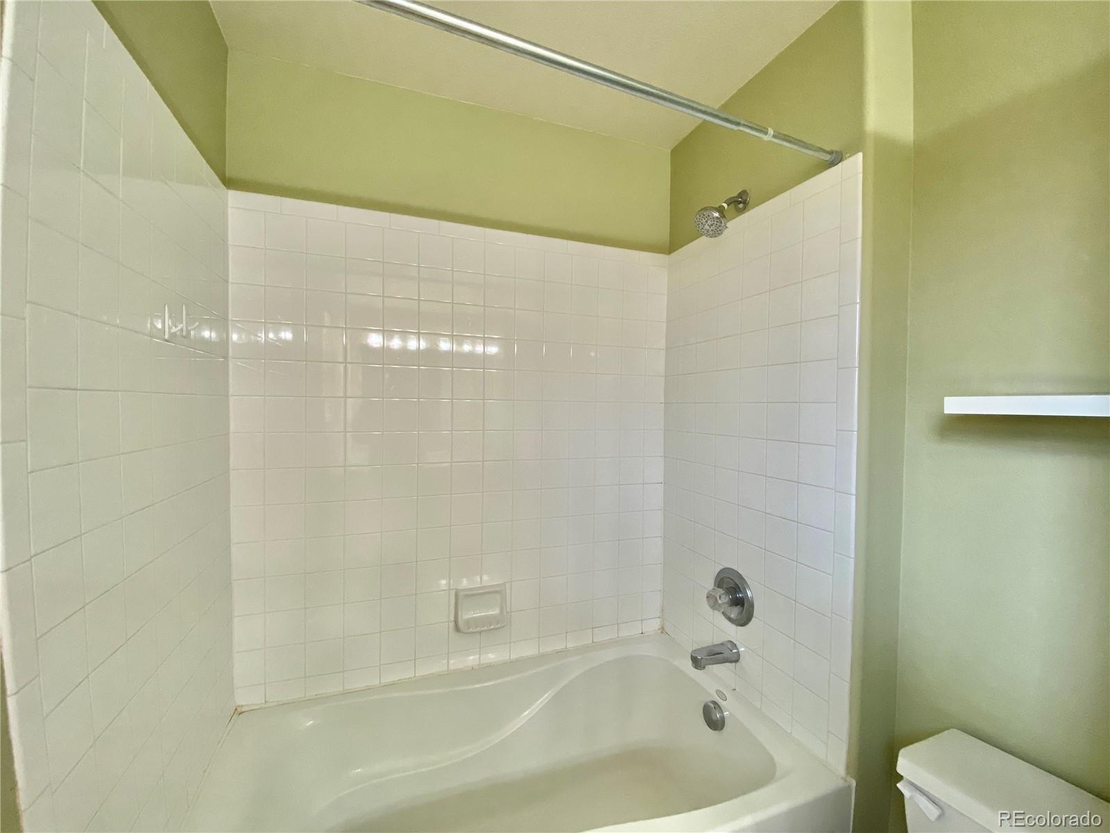 5731 Raleigh Circle Castle Rock, CO 80104 - Photo 11 of 16 a bathroom with a bathtub and a shower