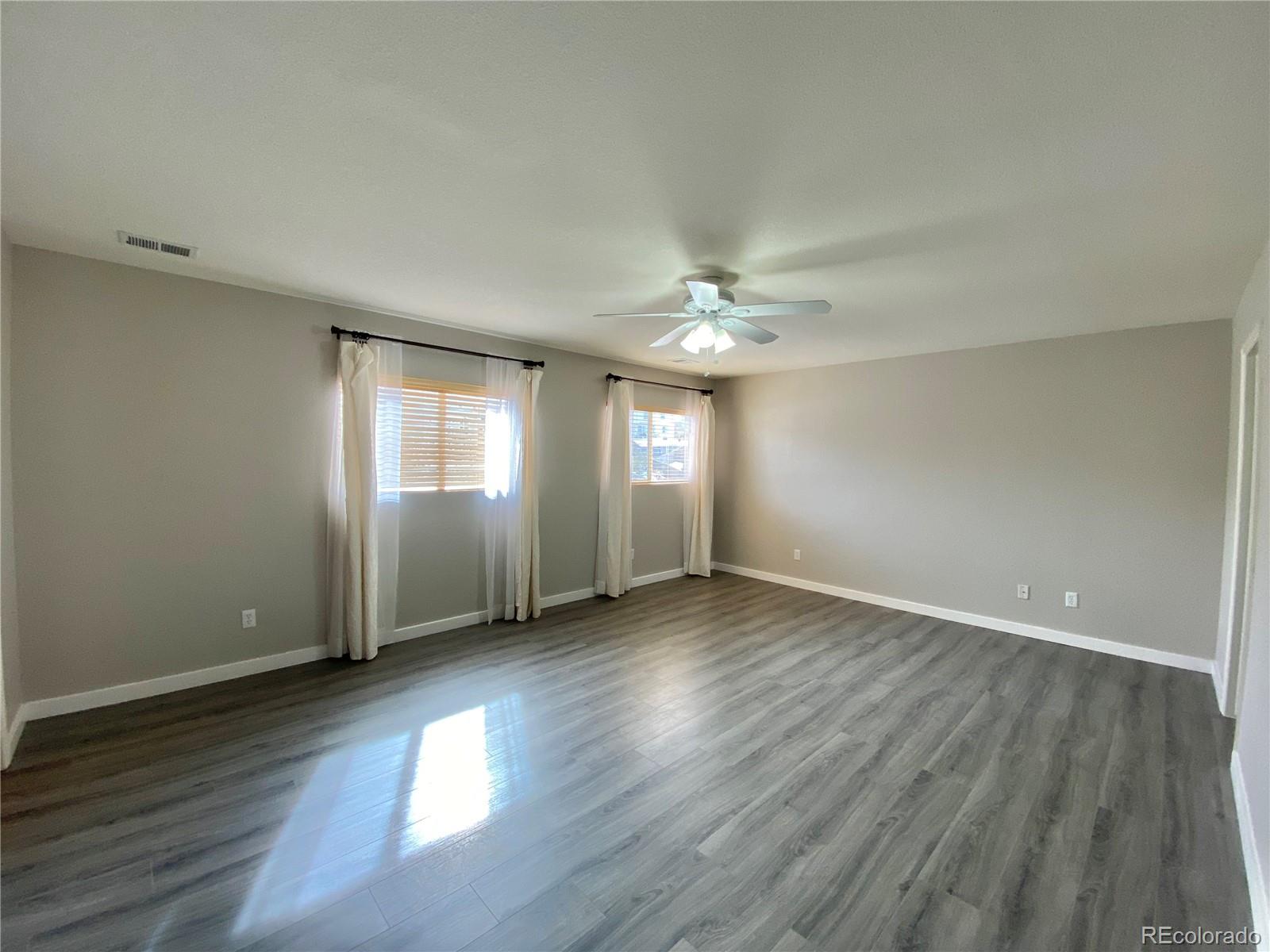 5731 Raleigh Circle Castle Rock, CO 80104 - Photo 7 of 16 a view of an empty room with wooden floor and window