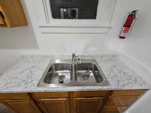 a kitchen with a sink and cabinets