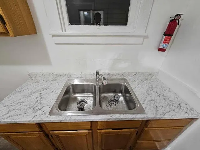 a kitchen with a sink and cabinets