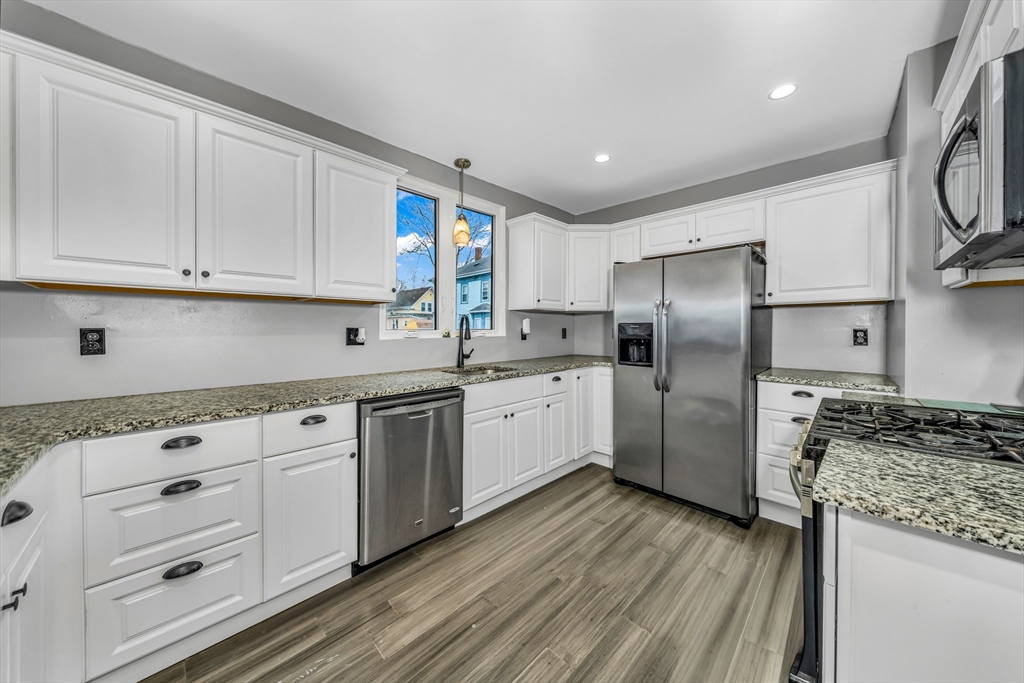 8 Ford Street Haverhill, MA 01832 - Photo 14 of 41 a kitchen with granite countertop a refrigerator sink and cabinets