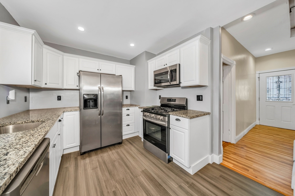8 Ford Street Haverhill, MA 01832 - Photo 15 of 41 a kitchen with stainless steel appliances granite countertop a stove a refrigerator and a sink