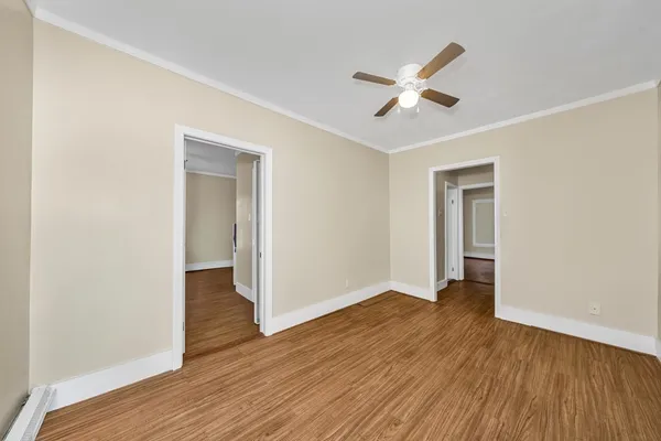 a view of empty room with wooden floor