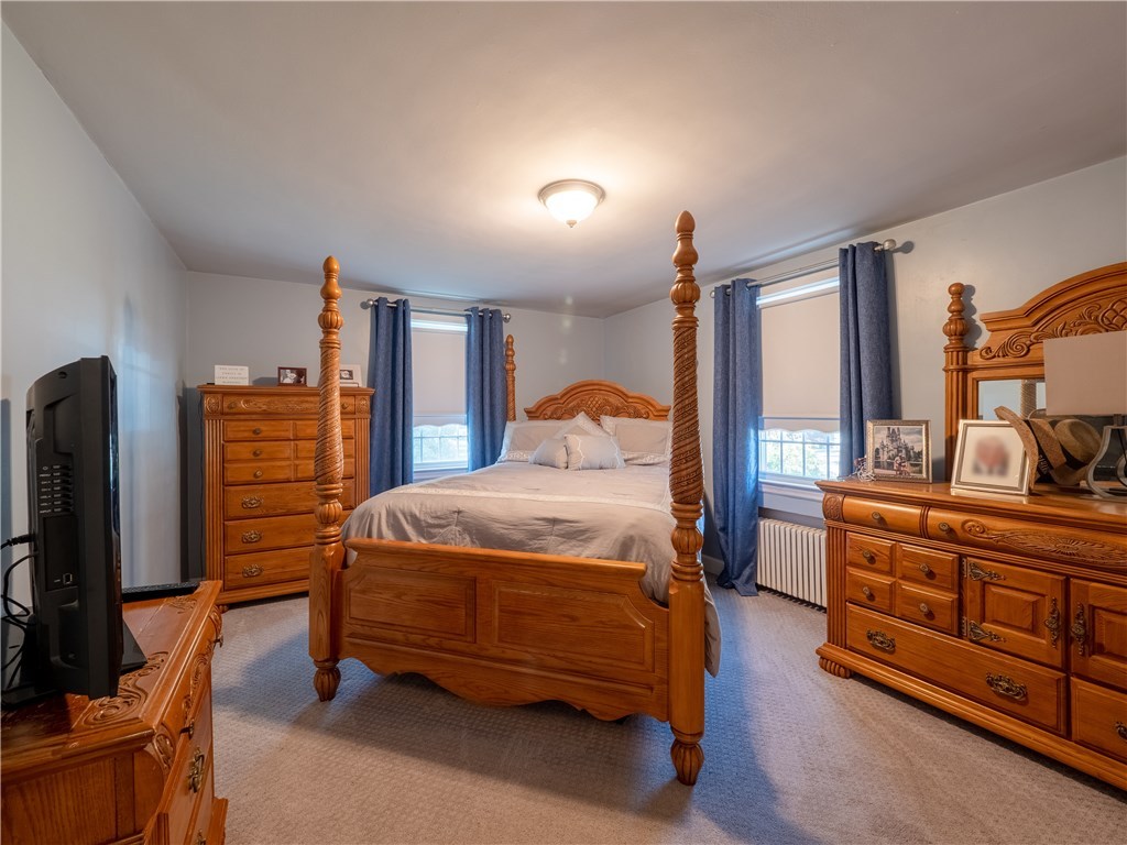 303 Crestwood Road Warwick, RI 02886 - Photo 13 of 43 First Floor Bedroom 1 w/ Hardwood Floors under the rug.