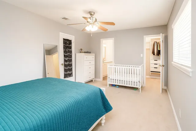 a view of a bedroom with a bed and a window