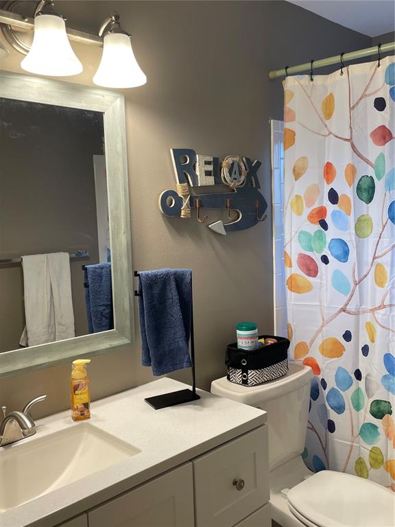 14531 Walsingham Road, Unit 203 Largo, FL 33774 - Photo 19 of 24 a bathroom with a sink mirror vanity and toilet