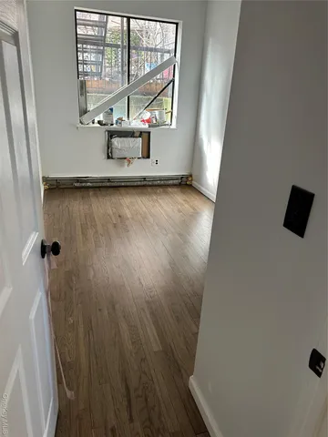 a view of a closet area with wooden floor