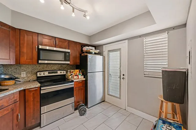 a kitchen with a refrigerator stove and microwave