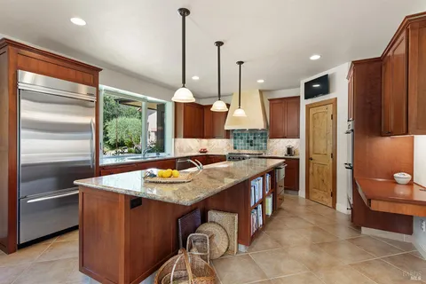 a kitchen with stainless steel appliances granite countertop a stove and a refrigerator