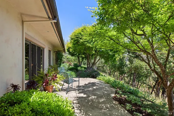 a view of a dining table and chairs in the patio