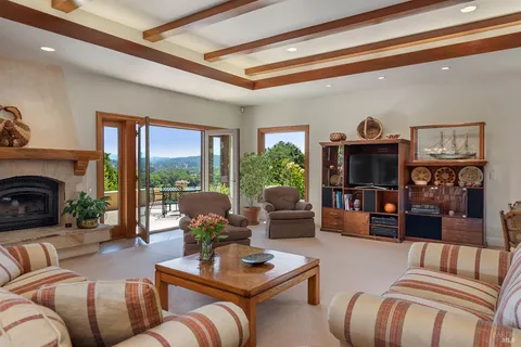 a living room with furniture fireplace and a large window