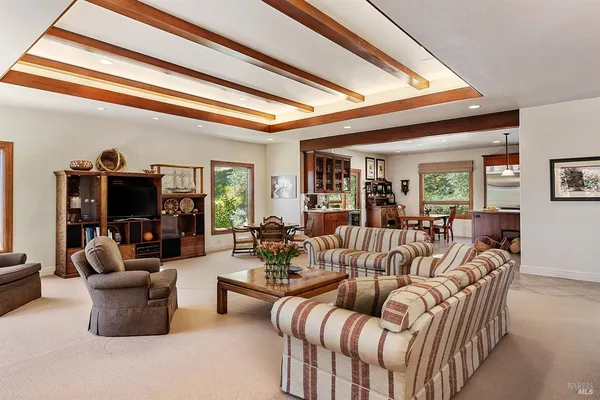 a living room with furniture fireplace and a large window