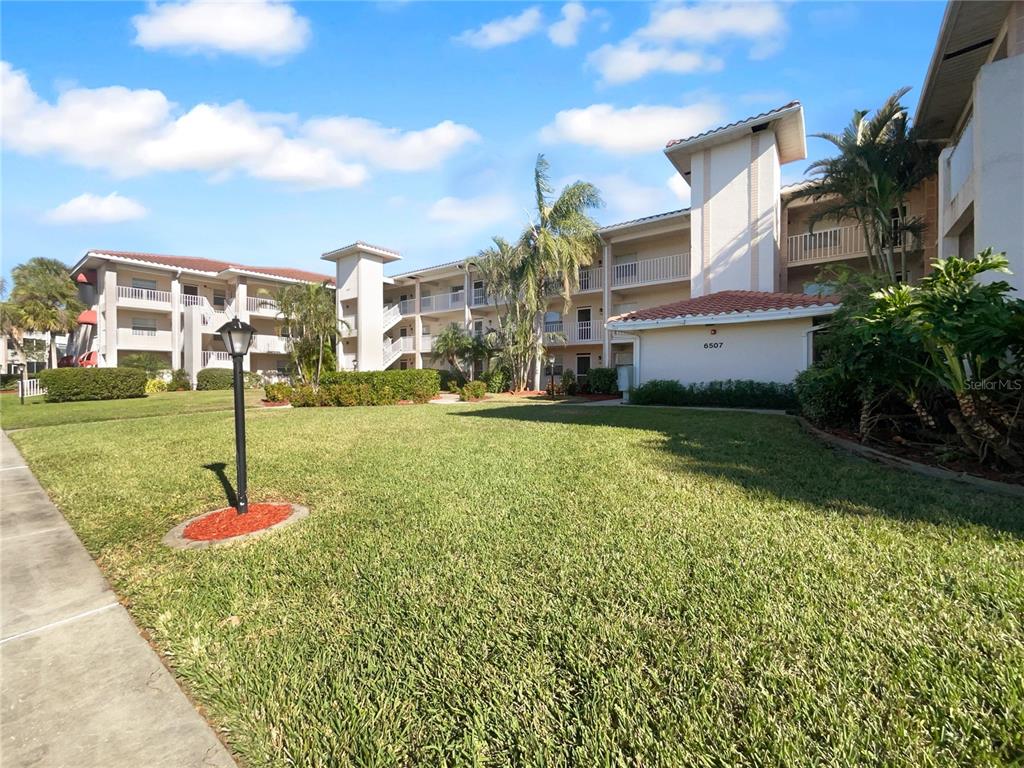 6507 Stone River Road, Unit 310 Bradenton, FL 34203 - Photo 1 of 1 a front view of a house with a yard