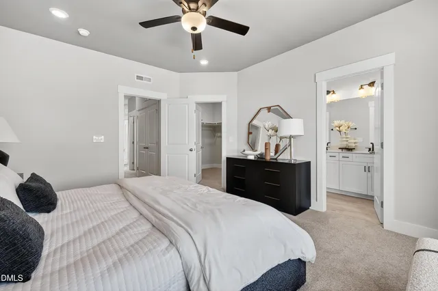a bathroom with a bathtub shower sink vanity mirror and toilet