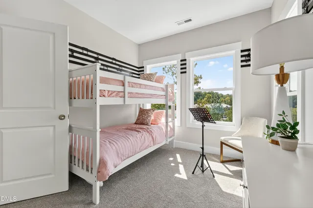 a large kitchen with granite countertop a stove oven and white cabinets