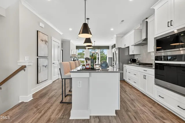 a dining room with furniture and wooden floor
