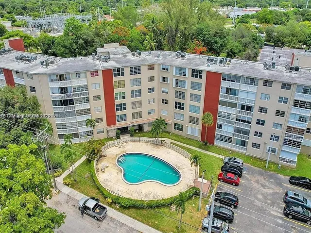 an aerial view of a house with a swimming pool and outdoor seating
