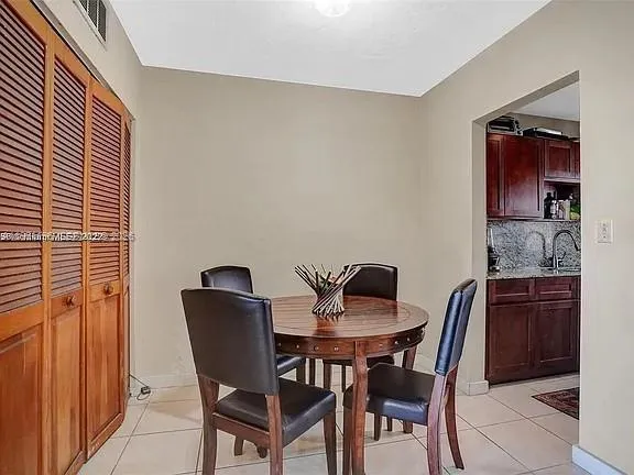 a view of a dining room with furniture and window