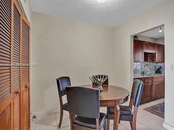 a view of a dining room with furniture and window