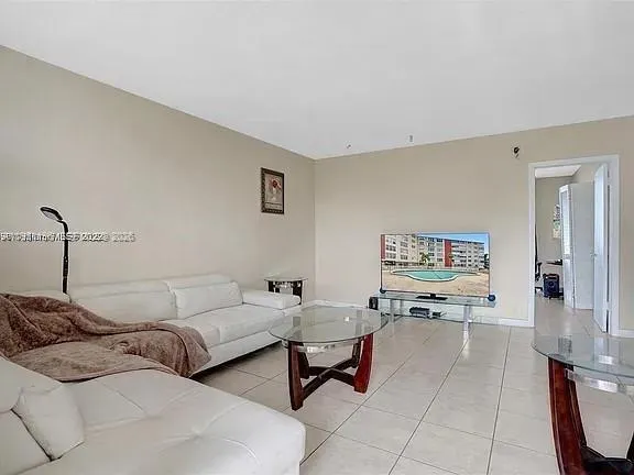 a living room with couches and a night stand