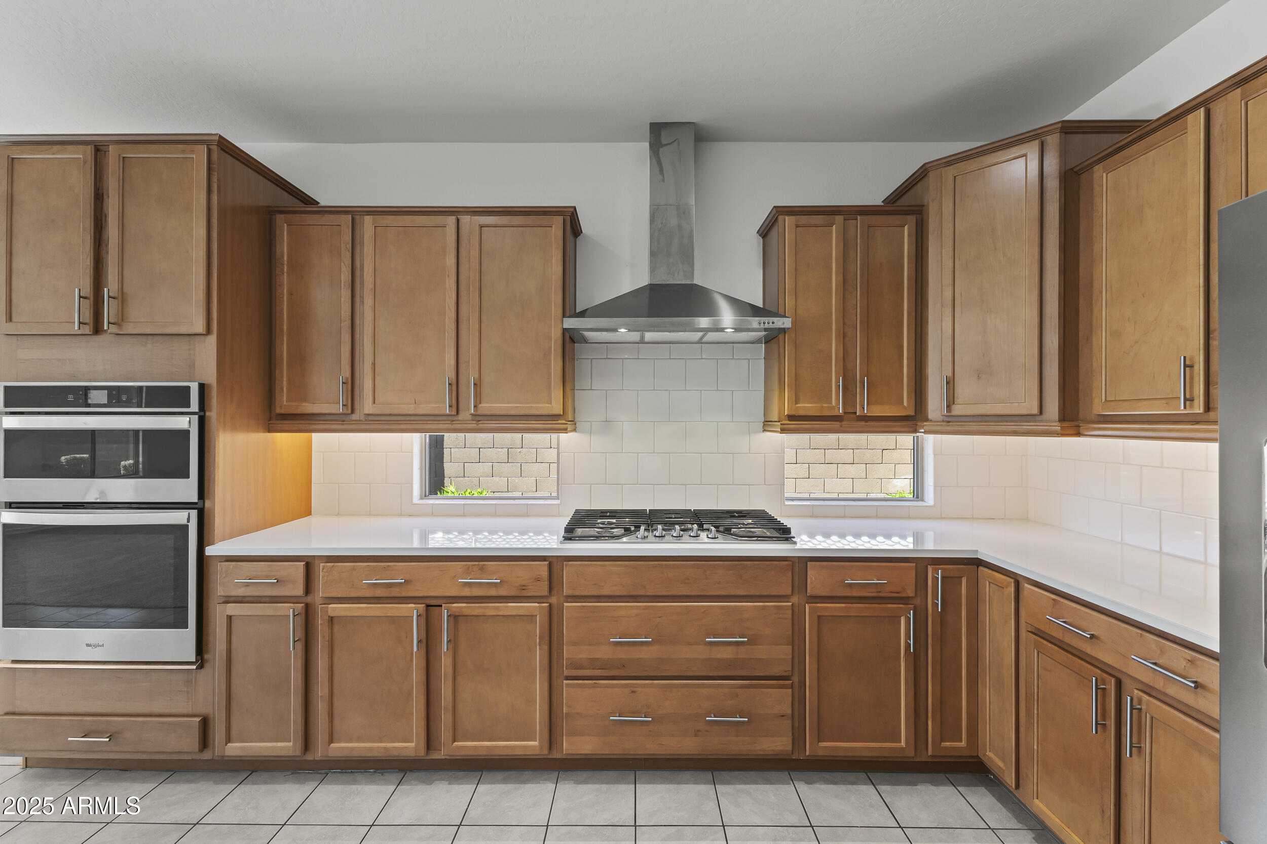 25915 West Quail Avenue Buckeye, AZ 85396 - Photo 21 of 73 a kitchen with stainless steel appliances granite countertop a sink and a stove