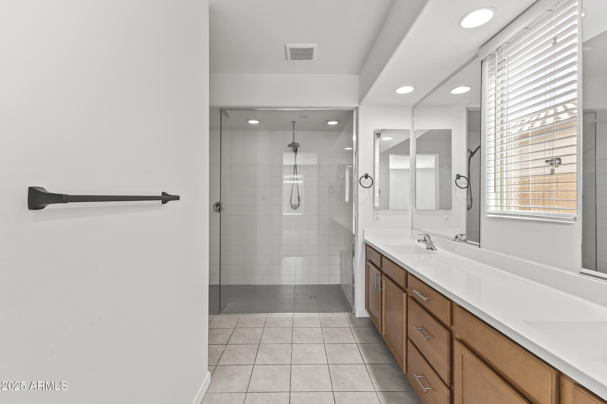 25915 West Quail Avenue Buckeye, AZ 85396 - Photo 32 of 73 a large bathroom with a granite countertop sink a toilet a mirror and shower