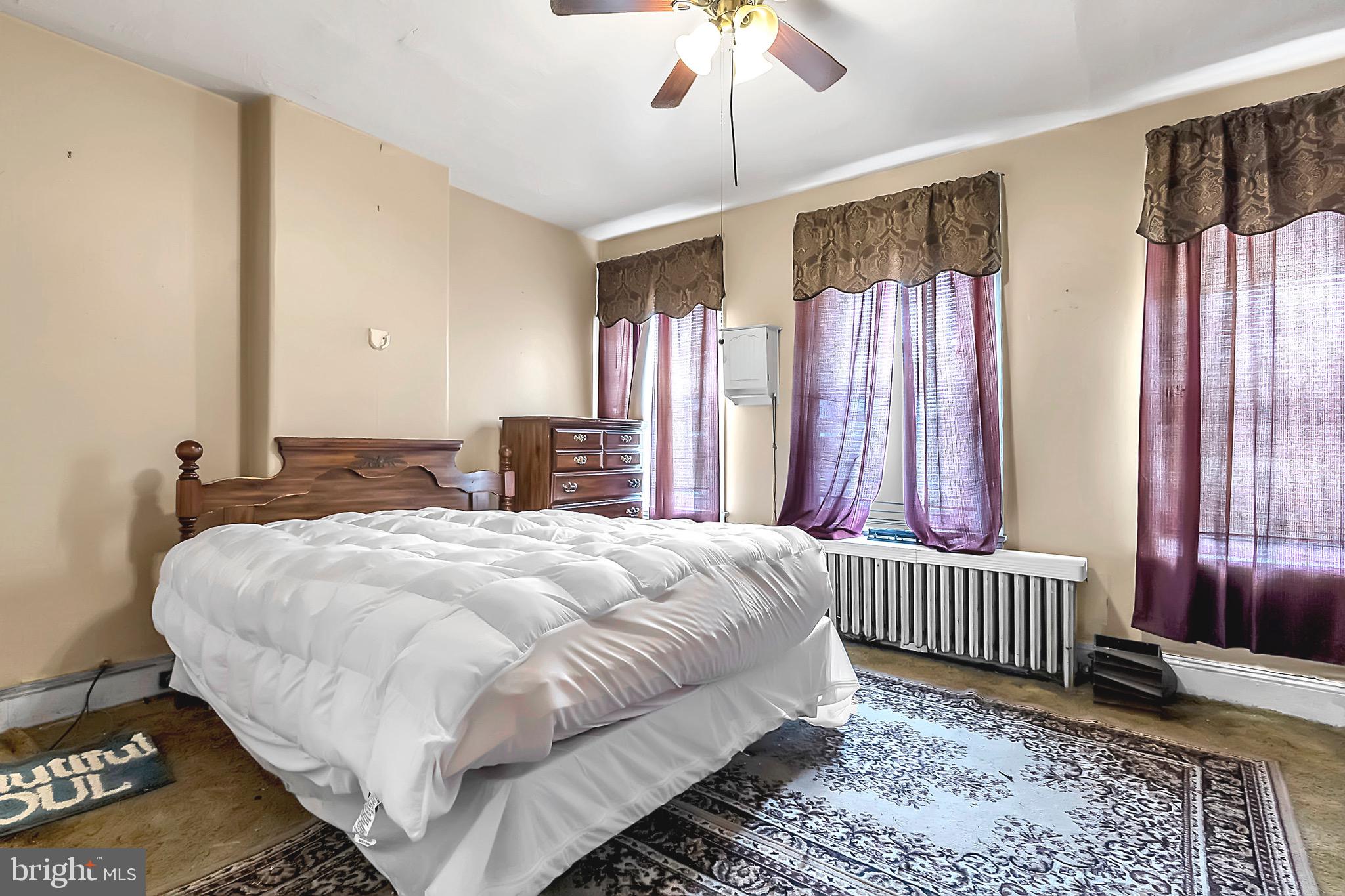 422 Rutherford Avenue Trenton, NJ 08618 - Photo 14 of 19 a bedroom with a bed and a window