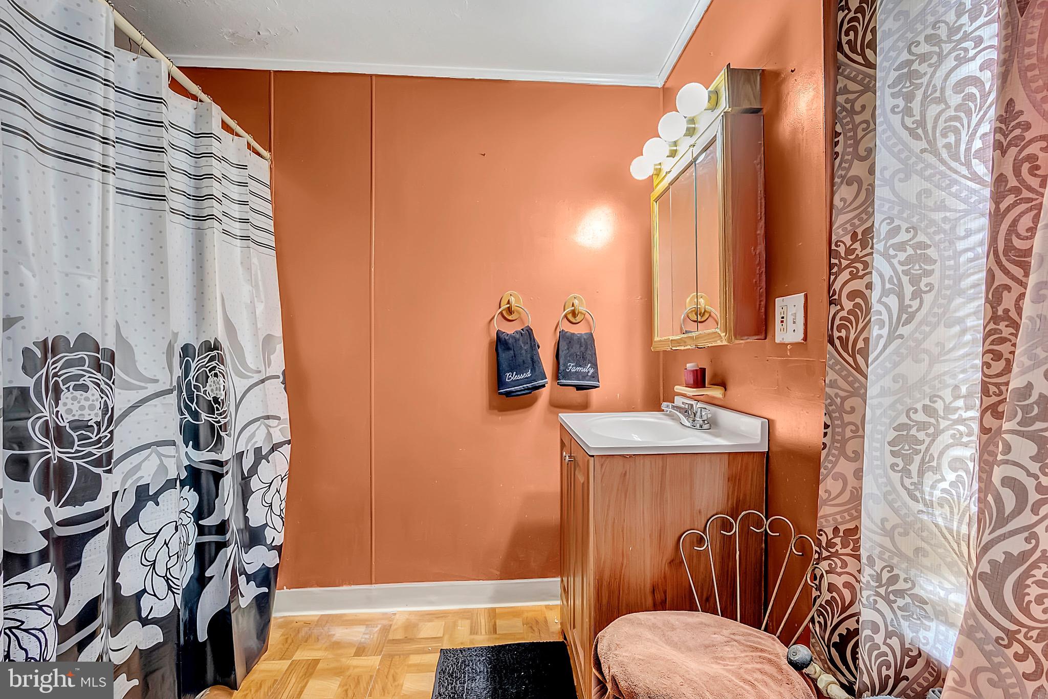 422 Rutherford Avenue Trenton, NJ 08618 - Photo 16 of 19 a bathroom with a sink and mirror with toilet