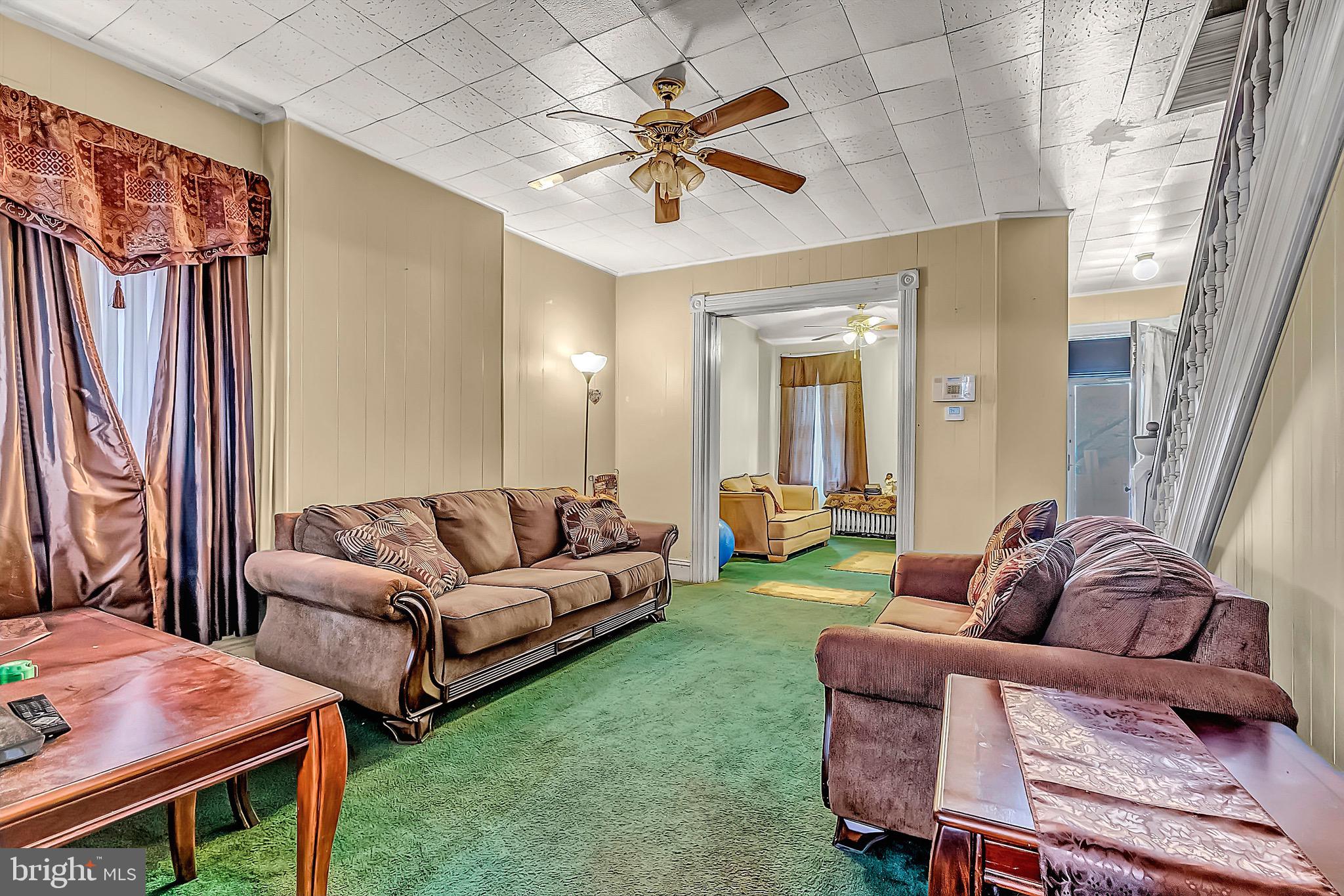 422 Rutherford Avenue Trenton, NJ 08618 - Photo 7 of 19 a living room with furniture and a large window